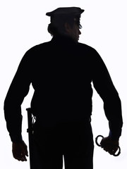 Silhouette of police officer with handcuffs in hand