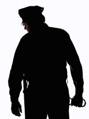 Silhouette of police officer with handcuffs in hand
