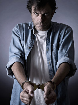 Man, mature, with handcuffs on