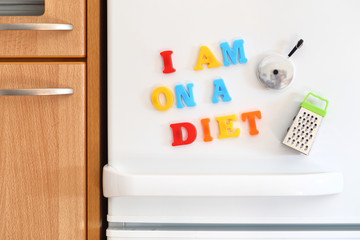 Refrigerators door with colorful text I Am On Diet Diet
