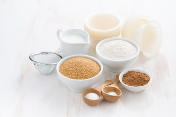 Ingredients for baking muffins on white wooden table