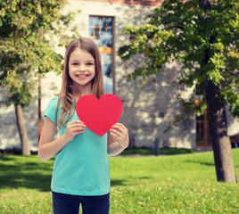 smiling little girl with red heart