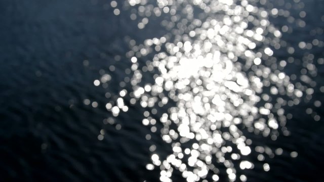 Sparkling water is shining on a sunny day in slow motion.