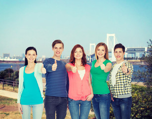 group of smiling students showing thumbs up