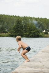 chłopiec skacze do wody - obrazy, fototapety, plakaty