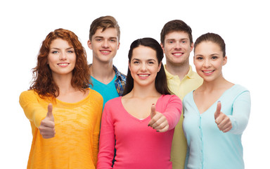 group of smiling teenagers showing thumbs up