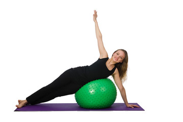 Young woman exercising with swiss ball