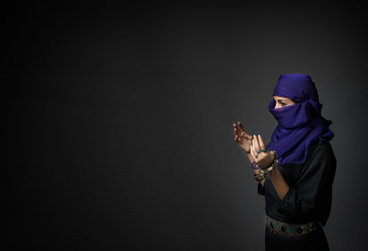 islamic woman praying with open hands