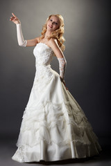 Lovely blonde posing in elegant wedding dress