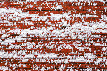 red brick wall covered with snow