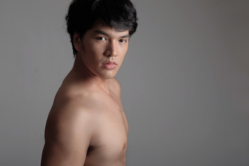 Fototapeta na wymiar Portrait of Handsome Asian male model in Shirtless