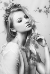 Naklejka premium Portrait of romantic tender blond girl with flowers in her hair