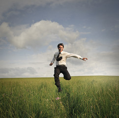 Businessman running in a field