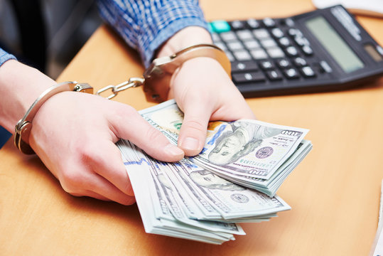 bribe concept. dollars and handcuffs
