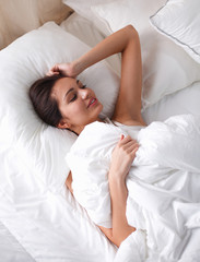 Obraz na płótnie Canvas Pretty woman lying in bed