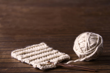 Ball of cream yarn with crochet hook