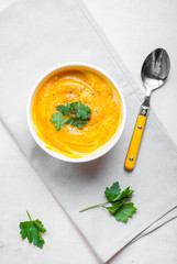Pumpkin soup with parsley background