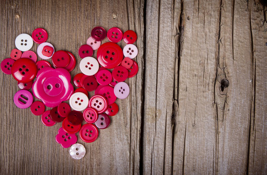 Sewing buttons in the shape of a heart