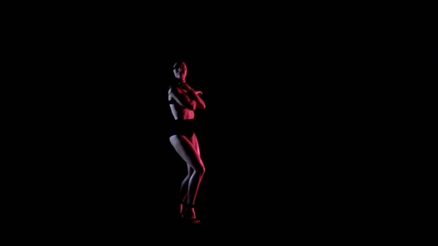 Sexy woman dancing, dark background