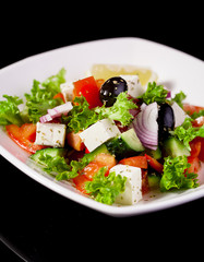 Fresh vegetable salad on a black background