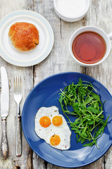 fresh breakfast with scrambled eggs and arugula