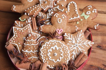 Gingerbread men with christmas cookies on a wooden background