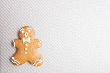 Happy gingerbread man over light grey textured background