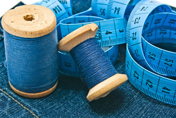 meter and spools of thread on denim