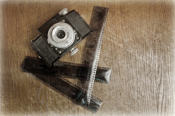 photo of an old camera and film, processed in retro style