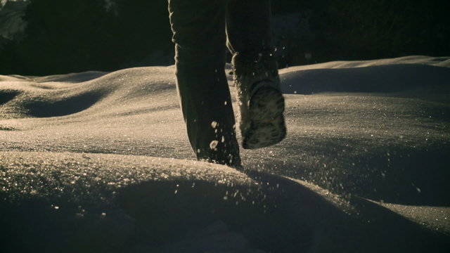 Woman walking on deep snow and cave, steady, slow motion 240fps