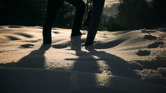 Couple walking together on the snow, steady, slow motion 240fps