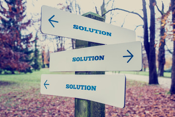 Signboard with the word Solution with arrows pointing in three d