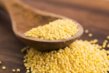 Millet on wooden spoon
