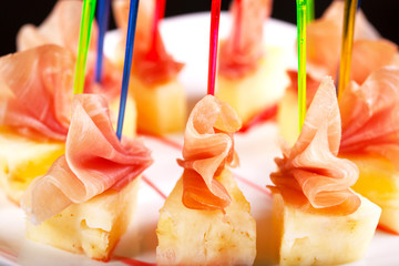 Canape with meat and pineapple.