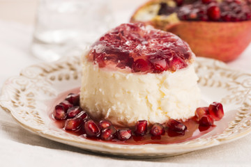 coconut panna cotta dessert with pomegranate