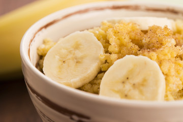 Fototapeta na wymiar Fresh millet porridge with banana
