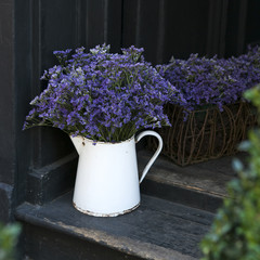 lavender in a beautiful vase costs on an old steps near the bla