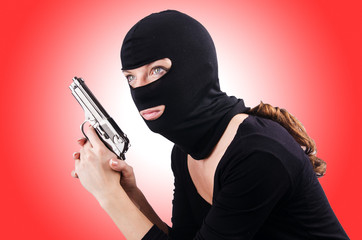 Criminal with gun isolated on white