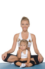 Fototapeta na wymiar Mom and daughter doing yoga on mat