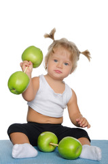 Fototapeta premium Little girl with weights of green apples