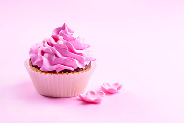Delicious cupcake on pink background