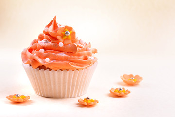 Delicious cupcake on beige background