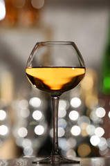 Glass of wine with bar on background