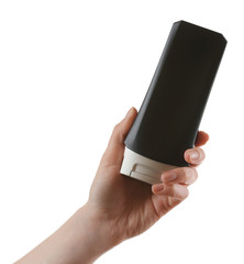 Female hand with cosmetics bottle isolated on white