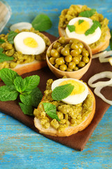 Sandwiches with green peas paste and boiled egg with napkin