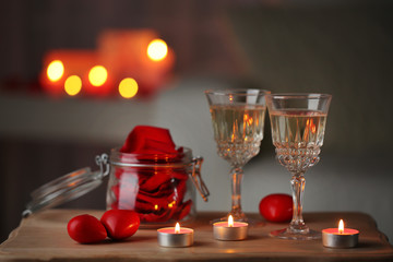 Champagne glasses and rose petals for celebrating Valentines