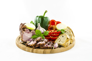 Fototapeta na wymiar Bacon and bread with vegetables on wooden board