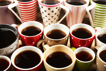 Many cups of coffee on wooden table background, closeup view
