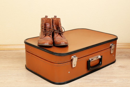 Vintage suitcase with male shoes