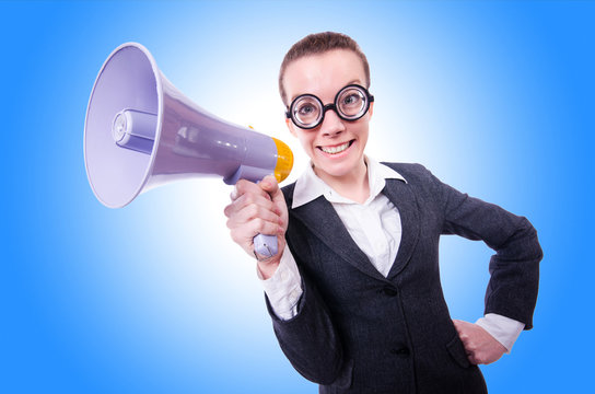 Young businessman with loudspeaker on white